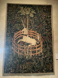 an image of a wall hanging with a deer on it's back and trees in the background