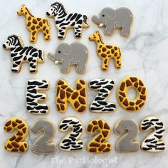 decorated cookies in the shape of numbers with zebras, giraffes and elephants