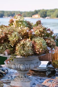 a vase filled with flowers sitting on top of a table