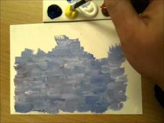 someone is painting something blue on the paper