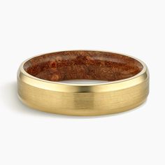 a yellow gold wedding band with a wooden inlay