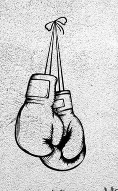 a black and white drawing of two boxing gloves hanging from a string on a wall