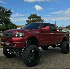 a red truck parked on top of a parking lot