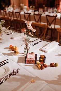 the table is set with flowers, candles and napkins for an elegant wedding reception