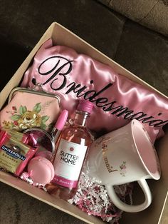 a pink box filled with personal care items and a coffee cup on top of it