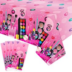 the table cloth is pink with polka dots on it and has various makeup products in different colors