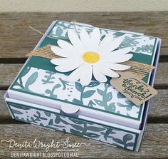 a card box with a white flower on it