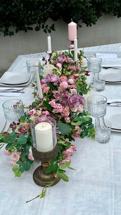 the table is set with flowers and candles for a formal dinner or special occasion,