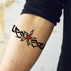 a person with a tattoo on their arm and the word star written in black ink