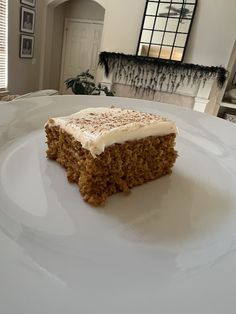 a piece of cake sitting on top of a white plate in front of a fireplace