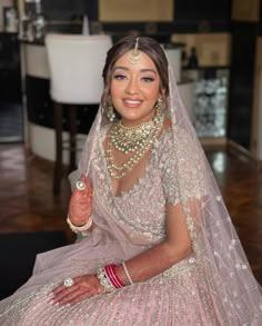 a woman in a wedding dress sitting on the floor