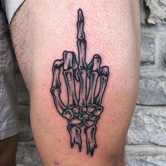 a man's leg with a skeleton hand tattoo on it