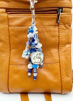 an orange purse with a clock hanging from it