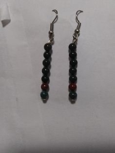 Genuine African bloodstone dangle earrings made by me. Bloodstone was the traditional birthstone for April in Victorian and Edwardian times. Bloodstone is an excellent blood cleanser and a powerful healing stone. It heightens intuition and increases creativity. It is grounding and protecting. Bloodstone draws off negative environmental energy, helping to overcome influences such as geopathic or electromagnetic stress. On surgical steel earrings with rubber backings to prevent slippage. Insurance mandatory. Price FIRM(No trades or bartering, I will not lower the price). Serious inquiries only-no flakes or spammers. Thanks. = ) African Bloodstone, Bead Dangle Earrings, Increase Creativity, Surgical Steel Earrings, Steel Earrings, Beaded Dangle Earrings, Etsy Earrings Dangle, Healing Stone, Beaded Dangles