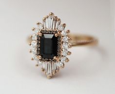 Vintage Black Onyx Starburst Engagement Ring, Art Deco Cluster Ring, Baguette Cut Black Onyx Ring, Antique Halo Wedding Ring, Ballerina Ring   ✥  Details ✥  - Stone: Gemstone / Moissanite/ Diamond/ CVD (Can Be Customize) - Metal Type: (White gold/ Yellow gold/ Rose gold, Sterling silver)  - Band Width: Approx. 1.5 MM - Cut: Emerald Cut - Center Stone Size:  MM - Clarity: VVS*/E-F  Ask For Quote if Required Real Diamond Ring   ✥ C U S T O M I Z A T I O N ✥  > The gemstone ring can be made of Morganite, Moissanite, Aquamarine, Emerald, Sapphire, Amethyst, Topaz, Tourmaline, Garnet, Ruby ETC. > For the marching band, I can custom-making the matching band according to your engagement ring, Let me know if you require this assistance.  > Ring can be personalized by diamond size and clarity. (exa Heidi Gibson, Telluride Wedding, Bijoux Art Deco, Halo Wedding Ring, Black Onyx Engagement Ring, Onyx Engagement Ring, Ring Baguette, Vintage Art Deco Rings, Emerald Cut Engagement