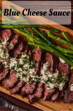 blue cheese sauce on top of steak and asparagus