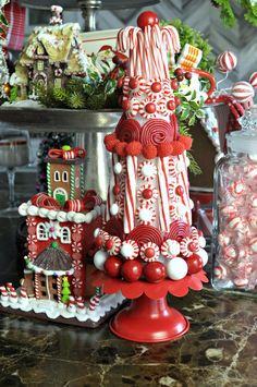 a christmas tree made out of candy canes and candies on a counter top