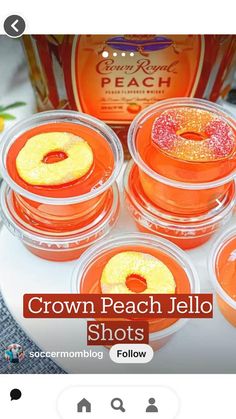 four orange jello shots sitting on top of a white plate next to a bottle