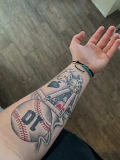 a man's arm with a baseball tattoo on it, and the number 10