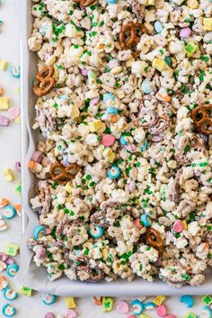 a white tray filled with cereal and pretzels