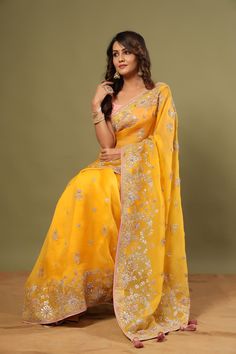 Look royal in this gorgeous mango yellow embroidered organza saree on festive occasions! It comes with a blouse piece. Disclaimer: The actual product may vary slightly from the image. These are custom orders, hence expect slight variation in color, placement of the motif or buta. ESTIMATED DELIVERYBecause this is a custom order, it would take about 4 weeks from the date of purchase. RETURN POLICYThis product is a custom order and cannot be returned or exchanged. Yellow Anarkali Style Pre-draped Organza Saree, Yellow Chanderi Traditional Wear For Reception, Yellow Pre-draped Saree With Resham Embroidery For Navratri, Yellow Resham Embroidered Pre-draped Saree For Festivals, Yellow Pre-draped Saree With Resham Embroidery For Festive Occasions, Yellow Pre-draped Saree With Resham Embroidery For Festive, Yellow Pre-draped Saree With Sheer Dupatta, Yellow Semi-stitched Pre-draped Saree With Resham Embroidery, Festive Yellow Pre-draped Saree With Resham Embroidery