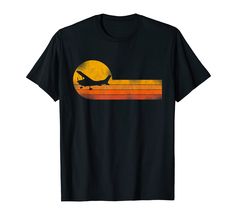 an airplane that is flying in the sky at sunset t - shirt for men and women