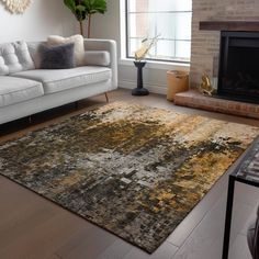 a living room with a couch, chair and rug on the floor in front of a fire place