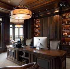 an elegant home office with wood paneling and built - in bookcases