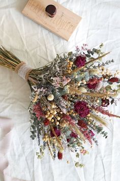 dried flowers are laid out on a white sheet