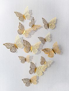 a group of gold and silver butterflies on a white background