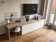 a flat screen tv mounted to the side of a wall next to a wooden floor