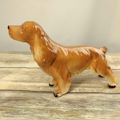 a brown dog figurine sitting on top of a wooden table