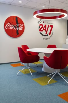 a conference room with red chairs and coca cola signs