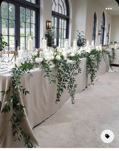 the table is set up with candles and greenery for an elegant wedding reception at midden lodge estate