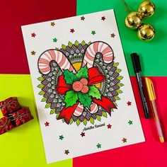 a christmas card with candy canes and bows on it next to some gold ornaments