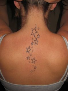 the back of a woman's neck with stars on it