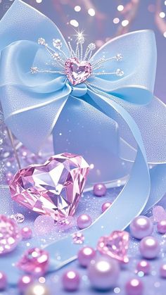 a pink diamond surrounded by pearls and ribbons with a blue bow on the top that has a crystal heart in it