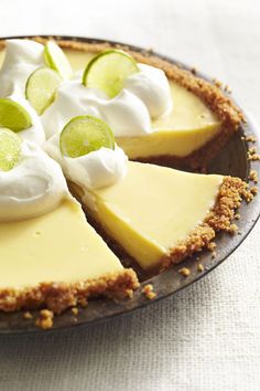 a pie with limes and whipped cream on top