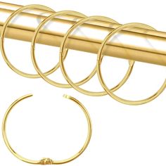 four pairs of gold hoop earrings on a white background