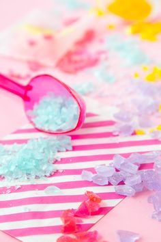 a pair of pink sunglasses sitting on top of a table covered in confetti