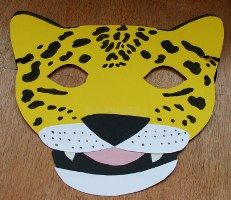 a yellow and black mask with a leopard's face painted on the front side