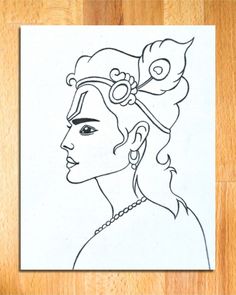 a drawing of a woman's face with a flower in her hair on a piece of paper