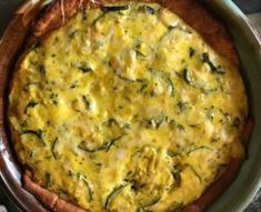 an omelet with spinach and cheese in a pan on a table top