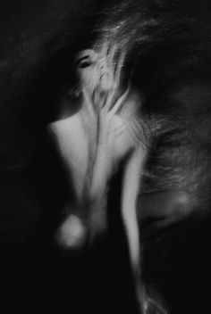 a black and white photo of a naked woman