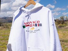 Classic street hoodie. Features a fully embroidered Monaco Racing Club Monte Carlo design. * 65% Cotton, 35% polyester * Front pouch pocket * Matching flat drawstrings * 3-panel hood WE RECOMMEND: * Order one size up for a more relaxed fit * Machine wash cold and hang dry or tumble dry with low heat Made to order. Designed by racers and motorsports enthusiasts in Laguna Beach, California. Please reach out to us if you have any issues with your order. Thank you for your support. Like this style? White Crew Hoodie With Logo Print, White Crew Hoodie For Sports Season, White Sports Hoodie With Embroidered Logo, White Hoodie With Embroidered Logo For Sports, Monaco Sweatshirt, Car Sweatshirt, Street Hoodie, Vintage Template, Racing Club