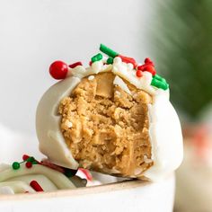 a white bowl filled with cake batter and candy canes on top of each other