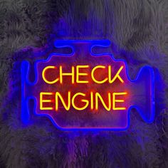 a neon sign that says check engine on the side of a furry animal's fur