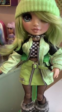 a doll with green hair is standing on a counter