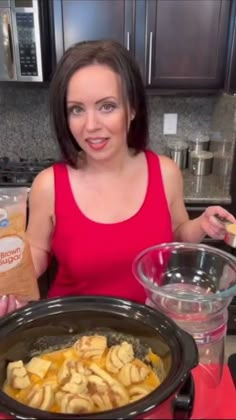 a woman standing in front of a crock pot filled with potatoes and other ingredients