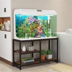 a fish tank sitting on top of a wooden shelf next to a white wall with plants in it